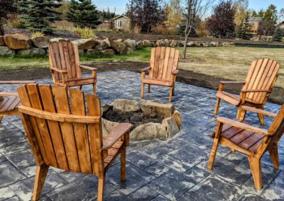 Wooden chairs placed around firepit